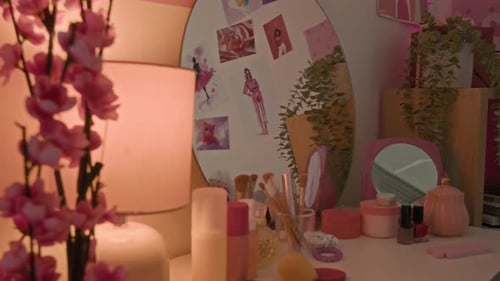 No People Shot of Pink Vanity Table with Cosmetics and Pink-Themed Posters