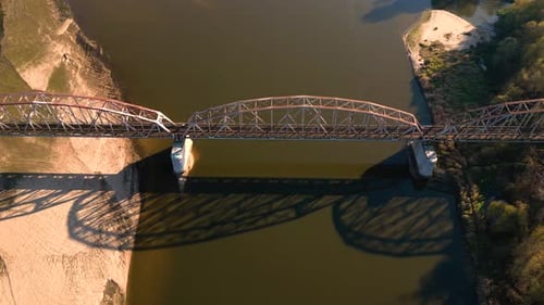 Old railway bridge over a river. Drone flight over bridge of old narrow gauge railway