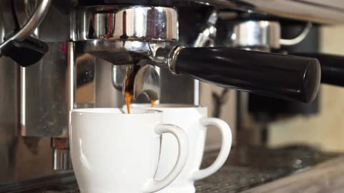 Espresso Machine Dispenses Coffee into Cups