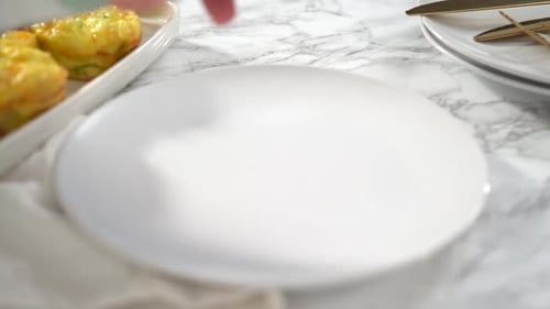 Step By Step Sliced Bacon and Cheese Egg Muffin on a White Plate