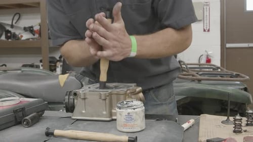 Engine Assembly by Mechanic in Workshop