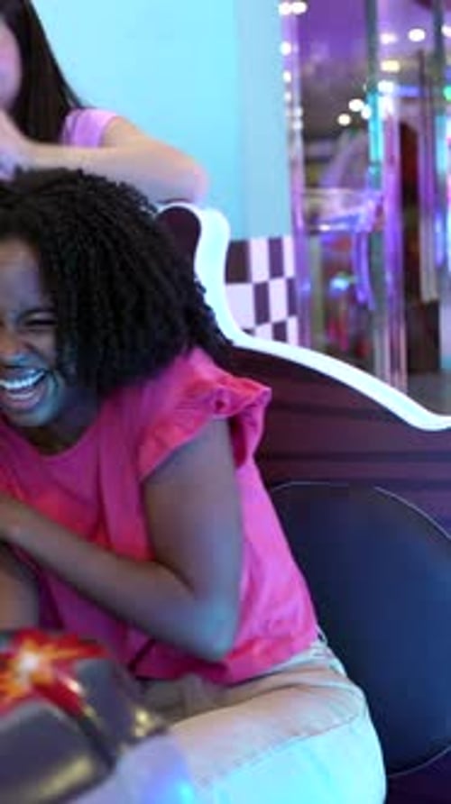 Teenagers Having Fun Playing Arcade Game