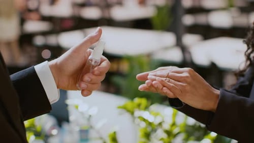 Colleagues Exchanging Hand Sanitizer in a Modern Corporate Office Environment