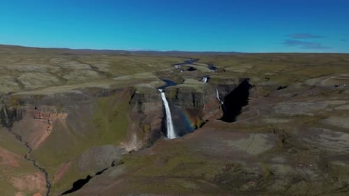 Haifoss Waterfalls With Rainbow Seen From The Highlands In Iceland. - aerial shot