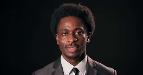 Smiling Young Adult Man in a Gray Suit