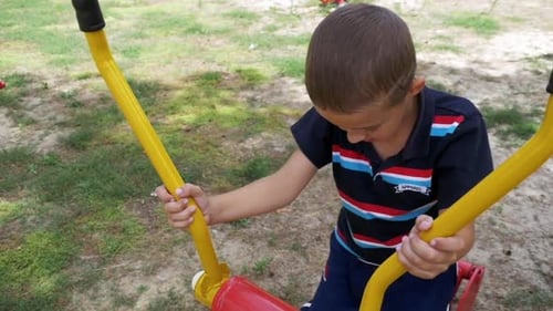 Child Boy Engaged on Sports Training Simulator at the Street in Slow Motion