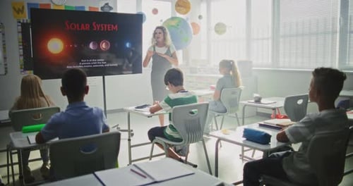 Astronomy Class Female Teacher Explaining Solar System to Primary School Children Using Digital