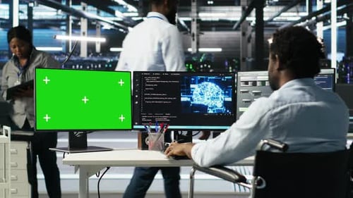 Data Center Worker with Paraplegia Using Node Trees on Green Screen PC