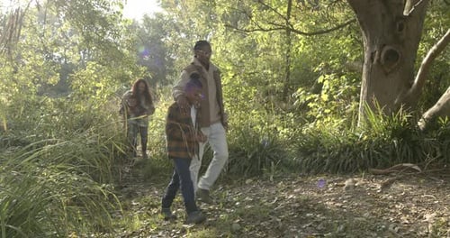 Family Enjoying Sunny Walk in Nature Park