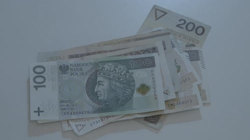 Pile of Polish Zloty Banknotes on Table