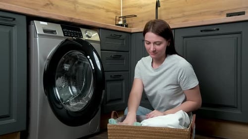 Woman Doing Laundry at Home, Loading Washer
