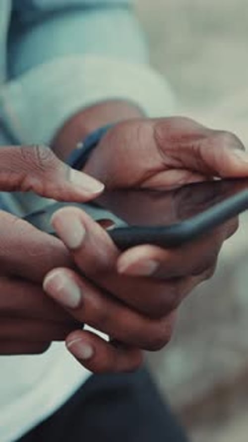 A CloseUp View of Hands Engaged with a Smartphone During a Relaxed and Casual Day