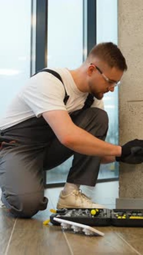Electrician Installing Wall Socket in Modern Home Interior