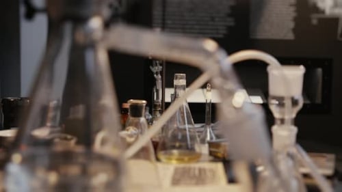 Glass Beakers and Lab Equipment in Dark Room
