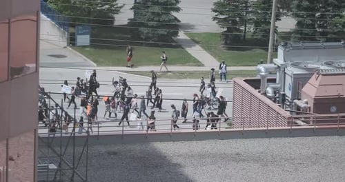 Group of Adults Walking Outdoors with Signs