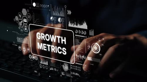 Business Growth Metrics on Digital Display with Hands Typing on Keyboard in Dark Environment. Asympt