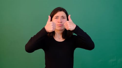 Woman Gives Double Thumbs Up on Green Screen