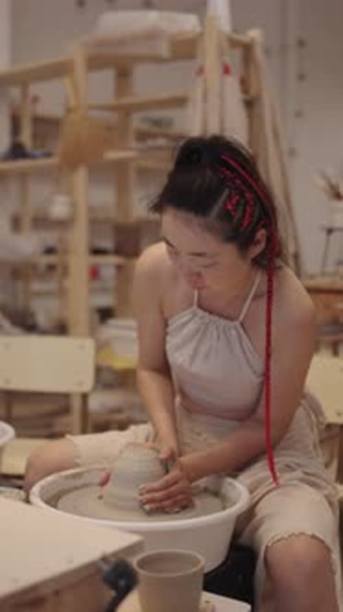 Potter Creating Ceramic Vessel on Pottery Wheel