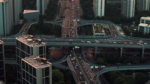 Urban Aerial View of Busy Highway Interchange in a Modern City with Flowing Traffic During Late