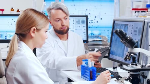 Scientists Analyzing Data in Modern Laboratory