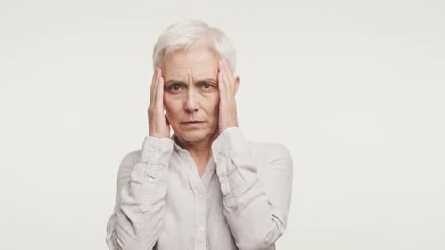 Stressed Senior Woman Holding Head