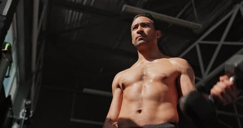 Dumbbell, workout and man in gym for body muscle, wellness or sports for health