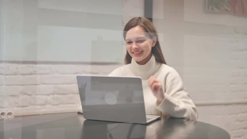 Young Woman Video Calling on Laptop at Home