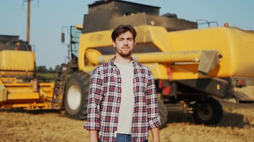 Portrait of Proud Harvester Machine Driver with Hands Crossing on Chest Farmer Standing at His