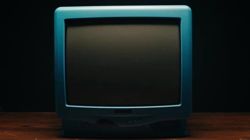 Hand Turns on Retro Blue Television to Static