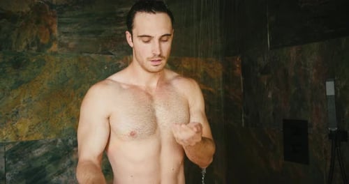 Man Washing Hair with Shampoo in Shower