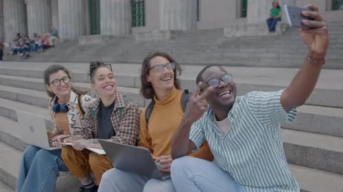 Group of Happy Students Taking Selfie on Stairs Outside University