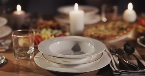 Beautifully Set Table with Food and Candlelight