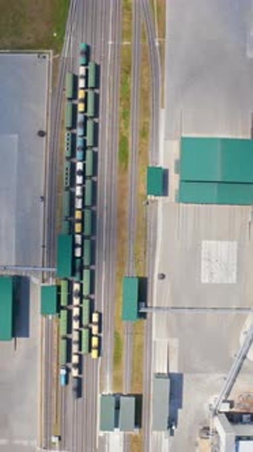 Modern agricultural architecture landscape. Big steel grain elevator warehouse. Vertical video