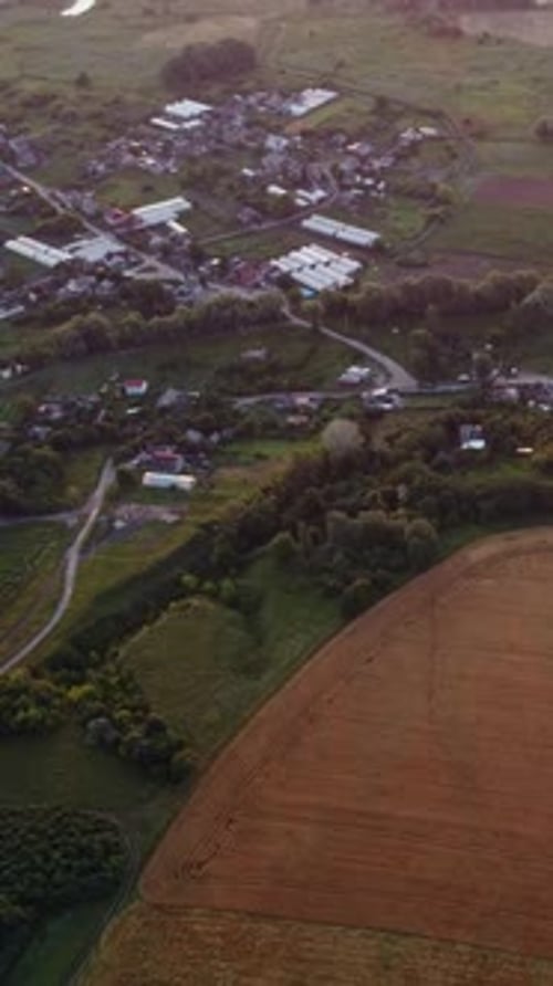 Sunrise Over Rural Village and Golden Fields