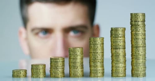 Stacks of Coins Forming Rising Bar Graph