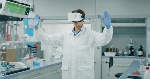 Portrait of futuristic researcher using the augmented reality vr glasses with hologram graphics fo