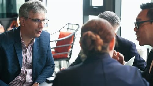 Business meeting with diverse professionals collaborating and discussing strategy at coworking area