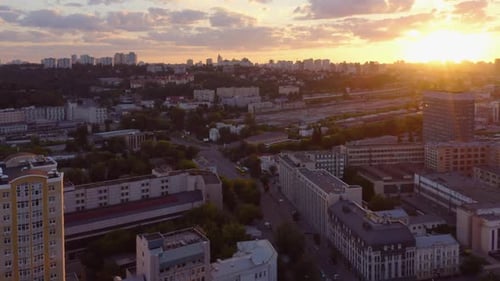 Breathtaking Aerial Sunset View of Beautiful City Buildings and Street with Cars Traffic