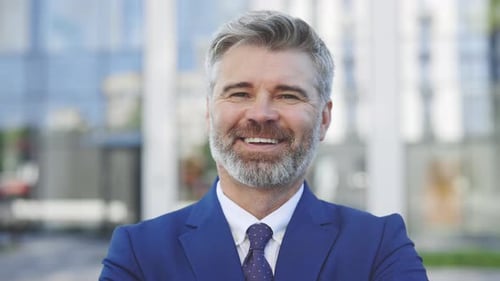 Close Up of Smiling Bearded Mature Business Man Looking on Camera While Standing Outdoors Near