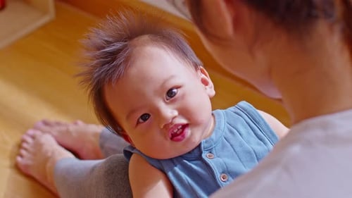 Close up asian baby smilingand laughing with her mother at warmth place. Asian mom talking and playi