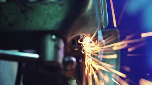 Professional Worker Works in Production with Metal