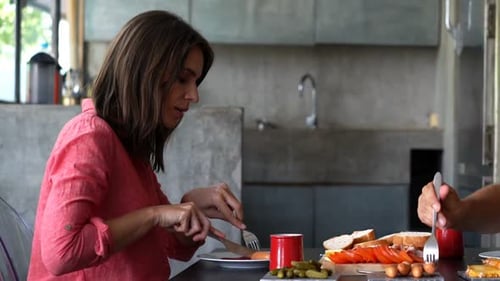 Couple Preparing Sandwiches at Home in Modern Kitchen