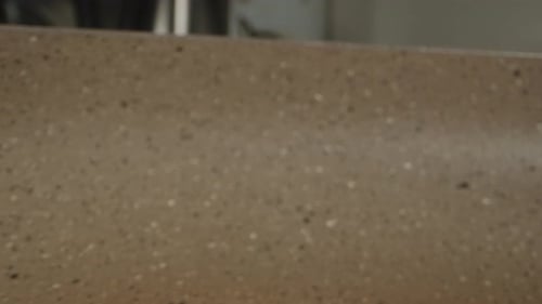 Pancake is fried in a frying pan. Dolly slider, extreme close-up.