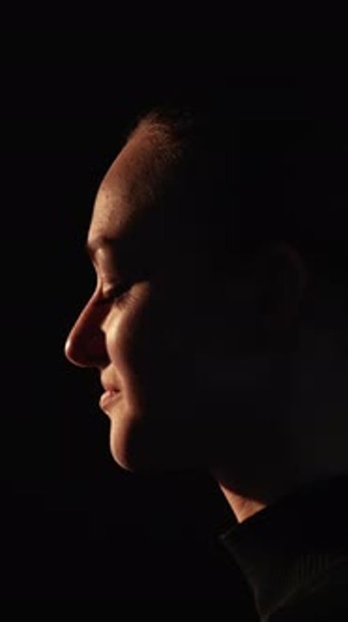 Woman Profile Portrait in Dramatic Lighting