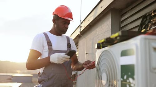 Man Using Tester for Measuring Strength in Air Conditioner