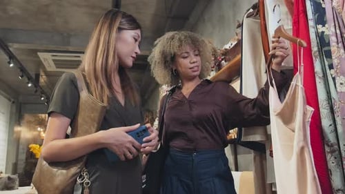 Female Friends Discussing Dress in Clothing Store