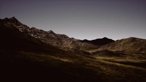 Twilight Mountain Landscape Showcasing Rugged Terrain and Shadows