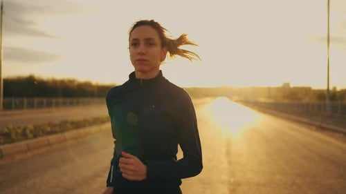 Woman Running Toward Camera at Golden Sunrise