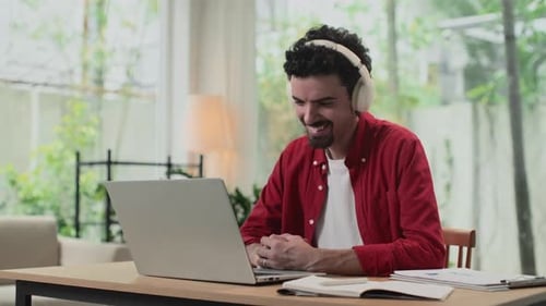 Young Adult Working on Laptop at Home