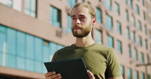 Young Adult Using Tablet in an Urban Setting